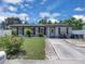 Well-maintained front yard with lush green grass, mature landscaping, and a brick-lined driveway at 517 Ivanhoe Way, Casselberry, FL 32707