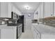 Kitchen with white cabinetry, stainless steel appliances, and tiled backsplash at 517 Ivanhoe Way, Casselberry, FL 32707