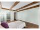 Large bedroom features wood floors, exposed beam ceiling, closet, and neutral paint at 5301 Burning Tree Dr # F, Orlando, FL 32811