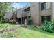 View of this condo's exterior, with a screened in porch, balcony, and exterior landscaping at 5301 Burning Tree Dr # F, Orlando, FL 32811