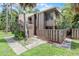 Two-story condo with light brown wooden siding and exterior stairways to the upper unit entrances at 5301 Burning Tree Dr # F, Orlando, FL 32811