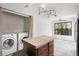 Updated kitchen features wood cabinets, stainless steel appliances, island, and an attached laundry room at 5301 Burning Tree Dr # F, Orlando, FL 32811