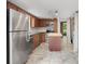 Updated kitchen features wood cabinets, stainless steel appliances, and kitchen island at 5301 Burning Tree Dr # F, Orlando, FL 32811
