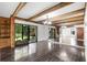 Bright living room featuring hardwood floors, white walls, wooden beams, and built in shelving at 5301 Burning Tree Dr # F, Orlando, FL 32811