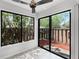 Cozy sunroom features a ceiling fan, tile floors and sliding glass doors leading to the patio at 5301 Burning Tree Dr # F, Orlando, FL 32811