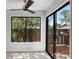 Cozy sunroom features a ceiling fan, tile floors and sliding glass doors leading to the patio at 5301 Burning Tree Dr # F, Orlando, FL 32811