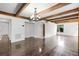 Living room featuring hardwood floors, white walls, exposed beams, and a bright airy feel at 5301 Burning Tree Dr # F, Orlando, FL 32811