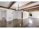 Living room featuring hardwood floors, white walls, exposed beams, and a bright airy feel at 5301 Burning Tree Dr # F, Orlando, FL 32811