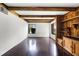 Bright living room with hardwood floors, white walls, wooden beams, and built in shelving at 5301 Burning Tree Dr # F, Orlando, FL 32811