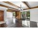 Spacious living room featuring hardwood floors, exposed wood beams, and lots of natural light at 5301 Burning Tree Dr # F, Orlando, FL 32811