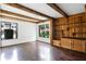 Bright living room featuring hardwood floors, white walls, wooden beams, and built in shelving at 5301 Burning Tree Dr # F, Orlando, FL 32811