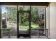 View from screened in porch with a view of the wooded backyard at 5301 Burning Tree Dr # F, Orlando, FL 32811