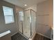 Modern bathroom featuring a glass-enclosed shower with white subway tile and sleek fixtures at 551 Pothos St, Apopka, FL 32703