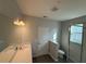 Bathroom featuring double sink vanity, tile floor and glass enclosed shower at 551 Pothos St, Apopka, FL 32703