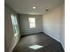 Cozy bedroom with modern dark-toned flooring and windows bringing in natural light at 551 Pothos St, Apopka, FL 32703