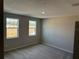 Bright bedroom with two windows and neutral carpeting providing lots of natural light at 551 Pothos St, Apopka, FL 32703