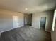 Spacious bedroom featuring neutral decor, carpet, and a walk-in closet, ready for your personal touch at 551 Pothos St, Apopka, FL 32703