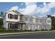 Beautiful three-story townhomes showcasing varied exterior paint schemes and charming architectural details in a modern neighborhood at 551 Pothos St, Apopka, FL 32703