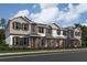 Beautiful three-story townhomes showcasing varied exterior paint schemes and charming architectural details in a modern neighborhood at 551 Pothos St, Apopka, FL 32703