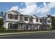 Beautiful three-story townhomes showcasing varied exterior paint schemes and charming architectural details in a modern neighborhood at 551 Pothos St, Apopka, FL 32703