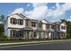 Beautiful three-story townhomes showcasing varied exterior paint schemes and charming architectural details in a modern neighborhood at 551 Pothos St, Apopka, FL 32703