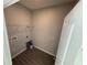 Convenient laundry room with tiled floor, storage shelving, and utility connections at 551 Pothos St, Apopka, FL 32703