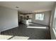 Bright living area with an open kitchen, white cabinets, modern flooring, and ample natural light at 551 Pothos St, Apopka, FL 32703