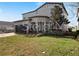 A spacious backyard and lawn surround this two-story house with an attached garage at 5550 Sabal Dr, St Cloud, FL 34771