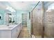 This bathroom boasts a double sink, large shower, and bright lighting, perfect for modern living at 5550 Sabal Dr, St Cloud, FL 34771