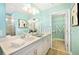 Beautiful bathroom featuring double sinks, sleek white cabinets, and tranquil colors at 5550 Sabal Dr, St Cloud, FL 34771