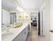Bright bathroom featuring a double vanity, a large mirror, and a neutral color palette at 5550 Sabal Dr, St Cloud, FL 34771