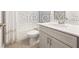 A well-lit bathroom with granite countertops, toilet, sink and a bathtub with a sliding door at 5550 Sabal Dr, St Cloud, FL 34771