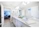 Bright and airy bathroom with a double vanity, large mirror, and modern decor at 5550 Sabal Dr, St Cloud, FL 34771