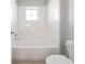 A clean bathroom with a white tiled shower-tub combo and white fixtures at 5550 Sabal Dr, St Cloud, FL 34771