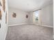 This bedroom features neutral walls, plush carpet, and a window with light-filtering curtains at 5550 Sabal Dr, St Cloud, FL 34771