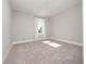 This bedroom boasts plush carpet, neutral walls, and a window with natural light at 5550 Sabal Dr, St Cloud, FL 34771