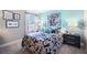 Beautiful bedroom with a comfortable bed, a nightstand and a decorative framed artwork at 5550 Sabal Dr, St Cloud, FL 34771