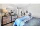 Stylish bedroom with a round mirror and a three-drawer wooden dresser at 5550 Sabal Dr, St Cloud, FL 34771