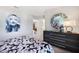 Bright bedroom featuring modern decor, painting and stylish round mirror at 5550 Sabal Dr, St Cloud, FL 34771