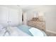 Cozy bedroom featuring a comfortable bed, dresser, and closet doors at 5550 Sabal Dr, St Cloud, FL 34771