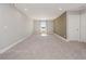 Carpeted upper level bonus room, with gray walls and a window providing a lake view at 5550 Sabal Dr, St Cloud, FL 34771