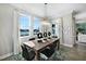 Formal dining room with elegant chandelier and large windows at 5550 Sabal Dr, St Cloud, FL 34771