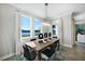 Bright dining room with a rustic table, modern light fixture, and serene lake view at 5550 Sabal Dr, St Cloud, FL 34771