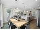 Dining room with modern chandelier overlooking a large kitchen island and modern appliances at 5550 Sabal Dr, St Cloud, FL 34771
