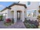 Close-up of stone-clad home entrance featuring an arched doorway and brick pathway at 5550 Sabal Dr, St Cloud, FL 34771