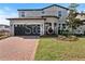 Charming two-story home with a brick driveway and attached two car garage at 5550 Sabal Dr, St Cloud, FL 34771