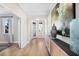 Bright and airy home foyer with wood floors, stylish console table, and decorative vases at 5550 Sabal Dr, St Cloud, FL 34771