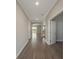 Inviting hallway with hardwood floors leads to an open living area and view of backyard at 5550 Sabal Dr, St Cloud, FL 34771