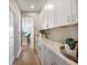 Hallway with extensive cabinetry and granite countertops, perfect for storage and display at 5550 Sabal Dr, St Cloud, FL 34771