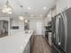 Modern kitchen features white cabinetry, stainless steel appliances, a large island and wood floors at 5550 Sabal Dr, St Cloud, FL 34771